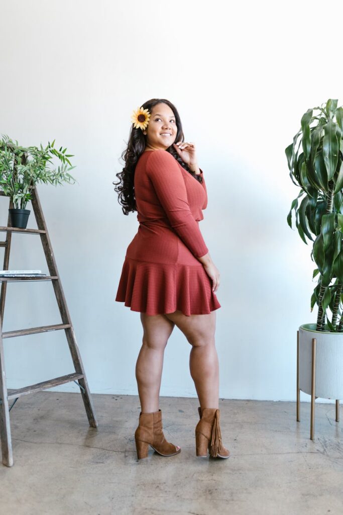 woman in red long sleeve mini dress standing beside plants - mannequin maigre