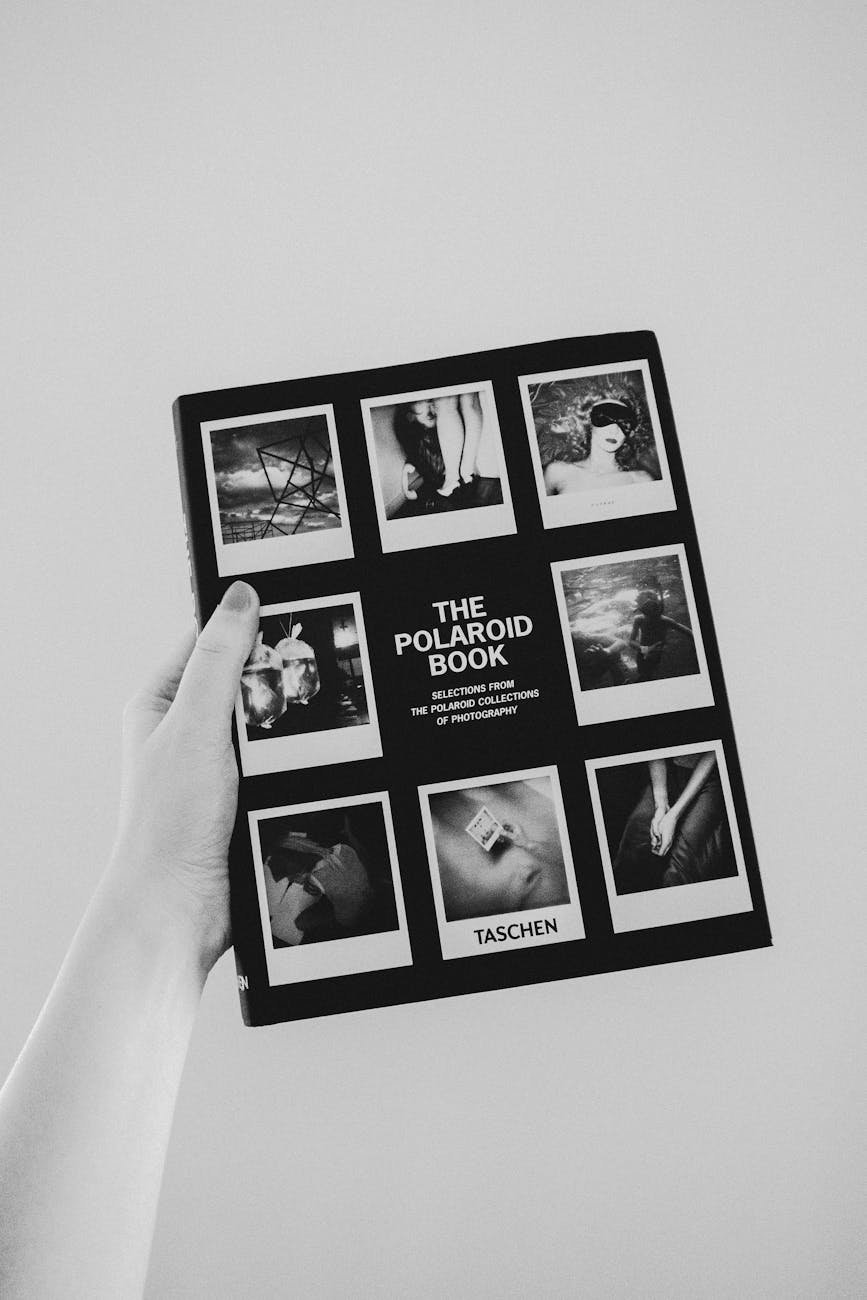 person holding the polaroid book